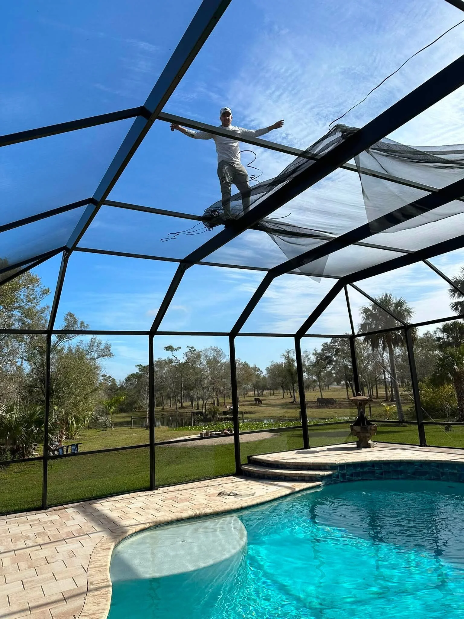 Complete pool cage restoration with full rescreening and stainless-steel screw replacement. 