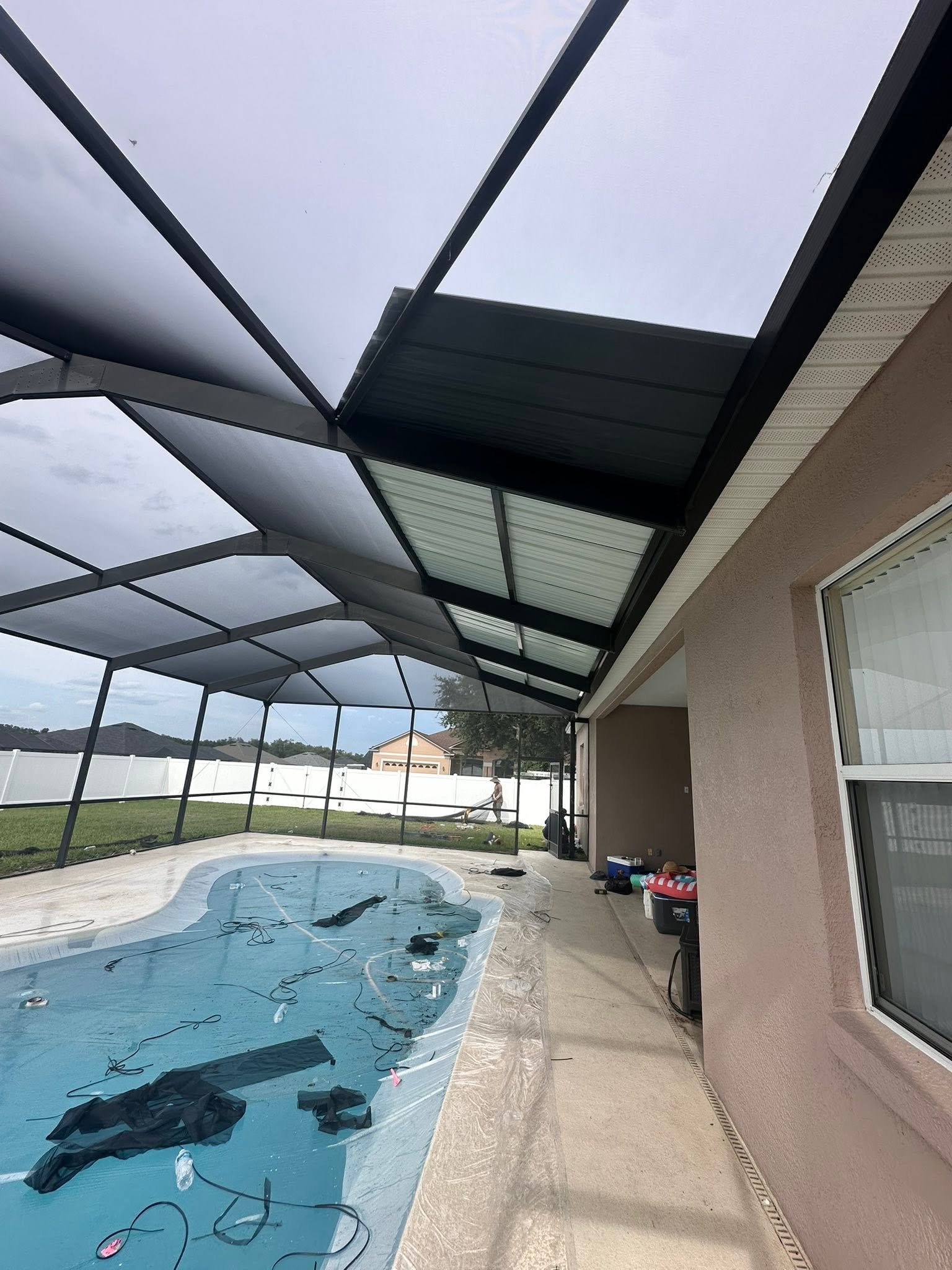 Professional gutter and super gutter installation designed to improve drainage and help protect pool enclosures, rooflines, and surrounding areas from water damage.