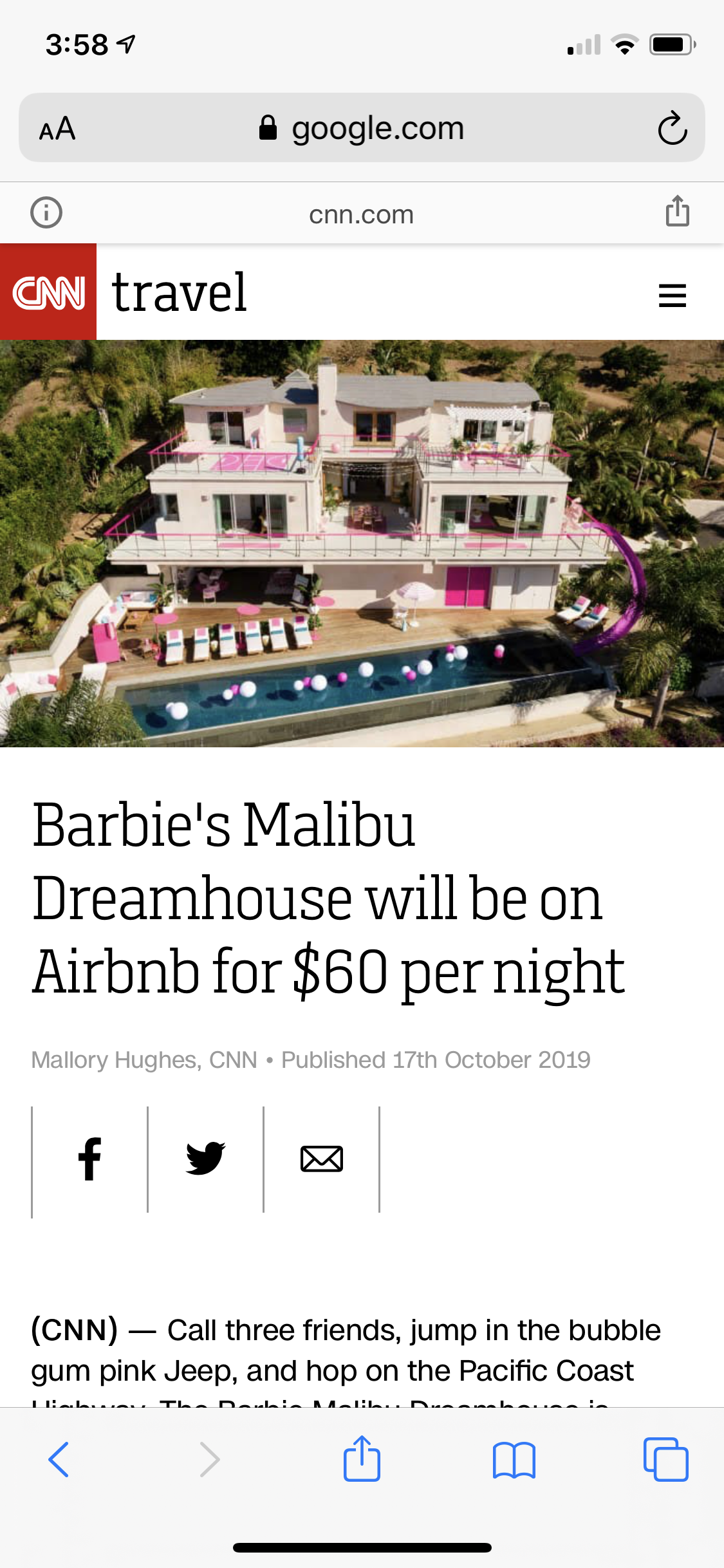 An aerial view of a large, modern white house with multiple balconies, pink accents, and a swimming pool with pink and white balloons in Malibu.