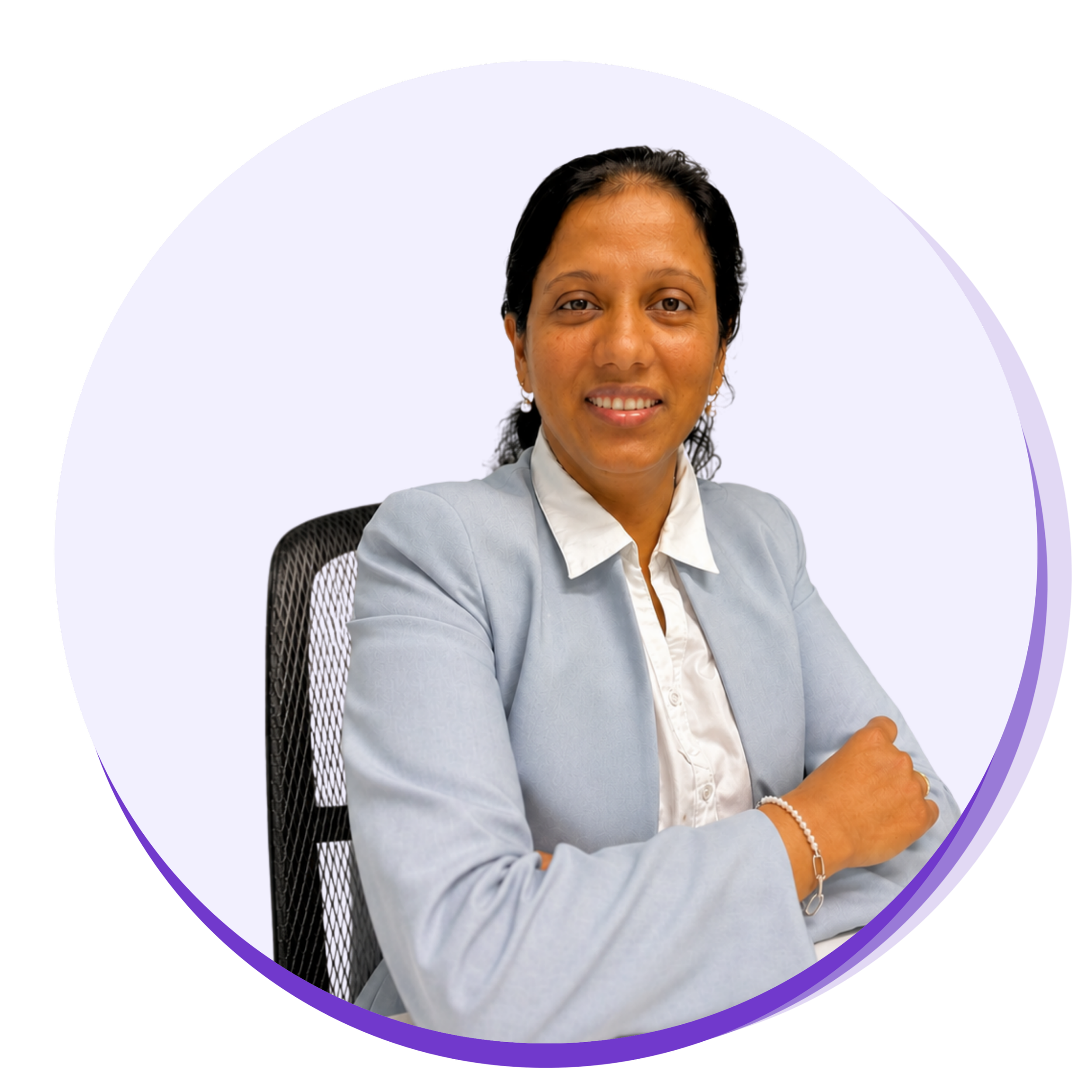 A woman sitting in a black mesh office chair, smiling, with her hands placed on her lap, wearing a light gray blazer and jewelry, against a background with a white ellipse and colorful geometric design.