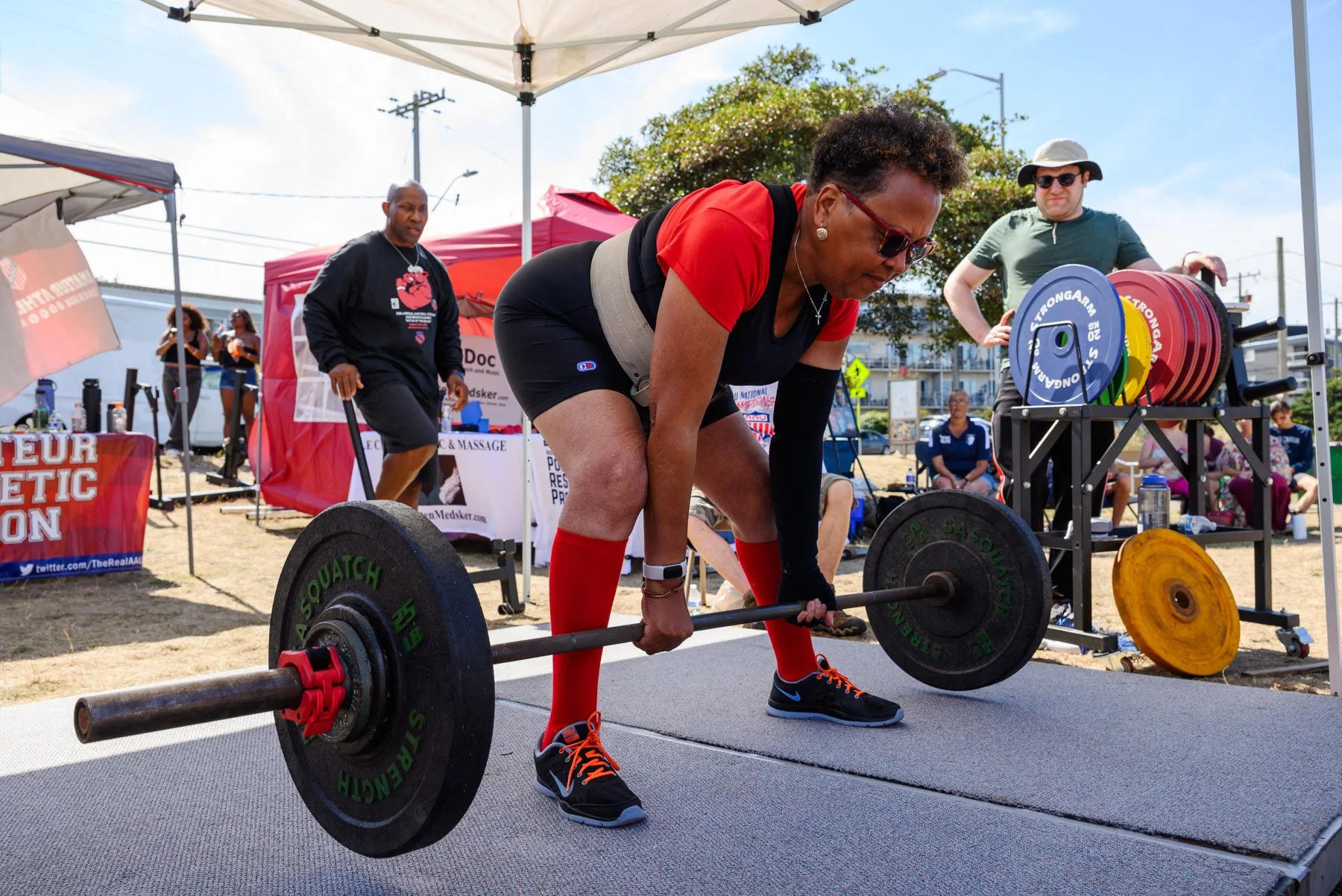 Middle aged woman about to do her deadlift at the Alki Beach powerlifting tournament.