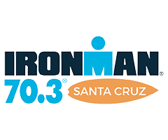 Ironman 70.3 Santa Cruz logo with stylized text and a circular icon above the 'I' in Ironman.