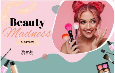 Young woman with pink hair holding makeup brushes, smiling, surrounded by makeup products, promoting beauty madness and shop now.