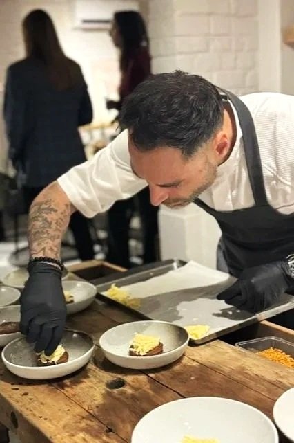 Carlo carefully plating a restaurant-quality dish for a private dining experience.