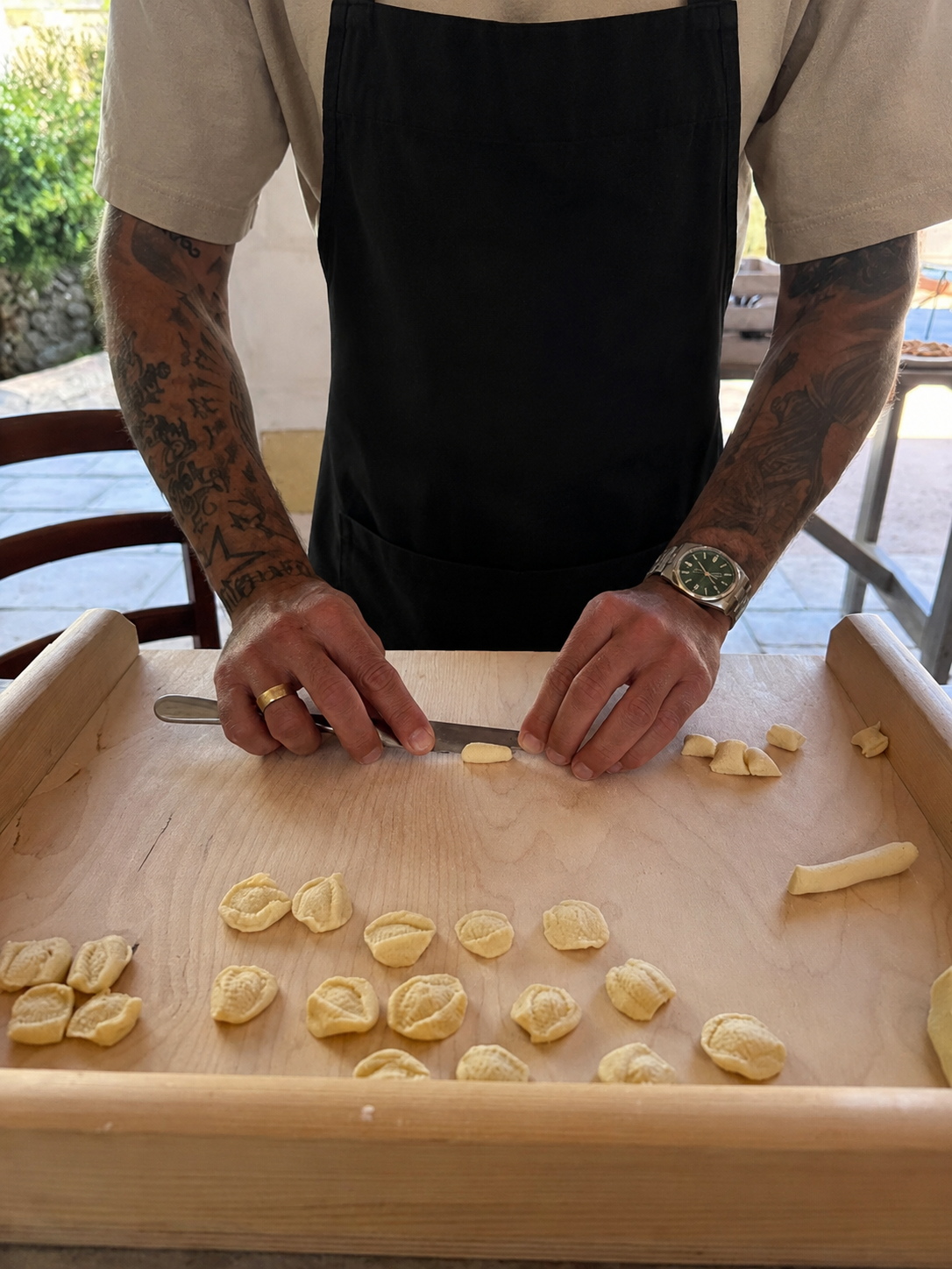 Carlo preparing fresh handmade pasta during a culinary workshop.