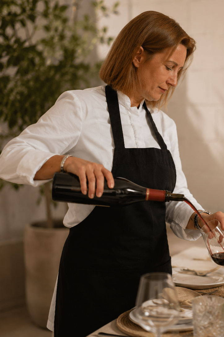 Vanessa serving wine during a private dining experience.