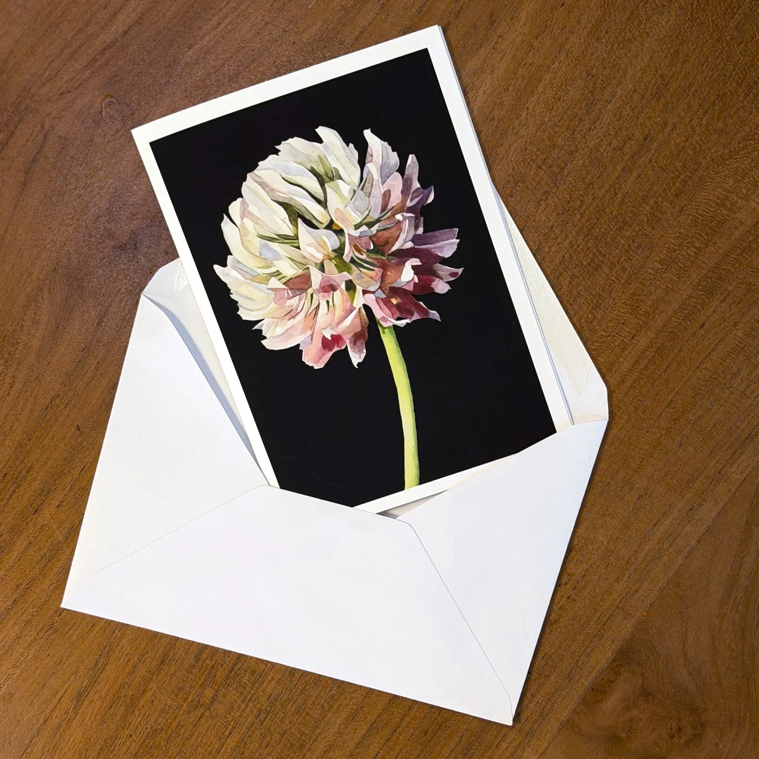 Botanical greeting card featuring a delicate watercolor flower illustration, presented with a white envelope and Alice Botanica branding.