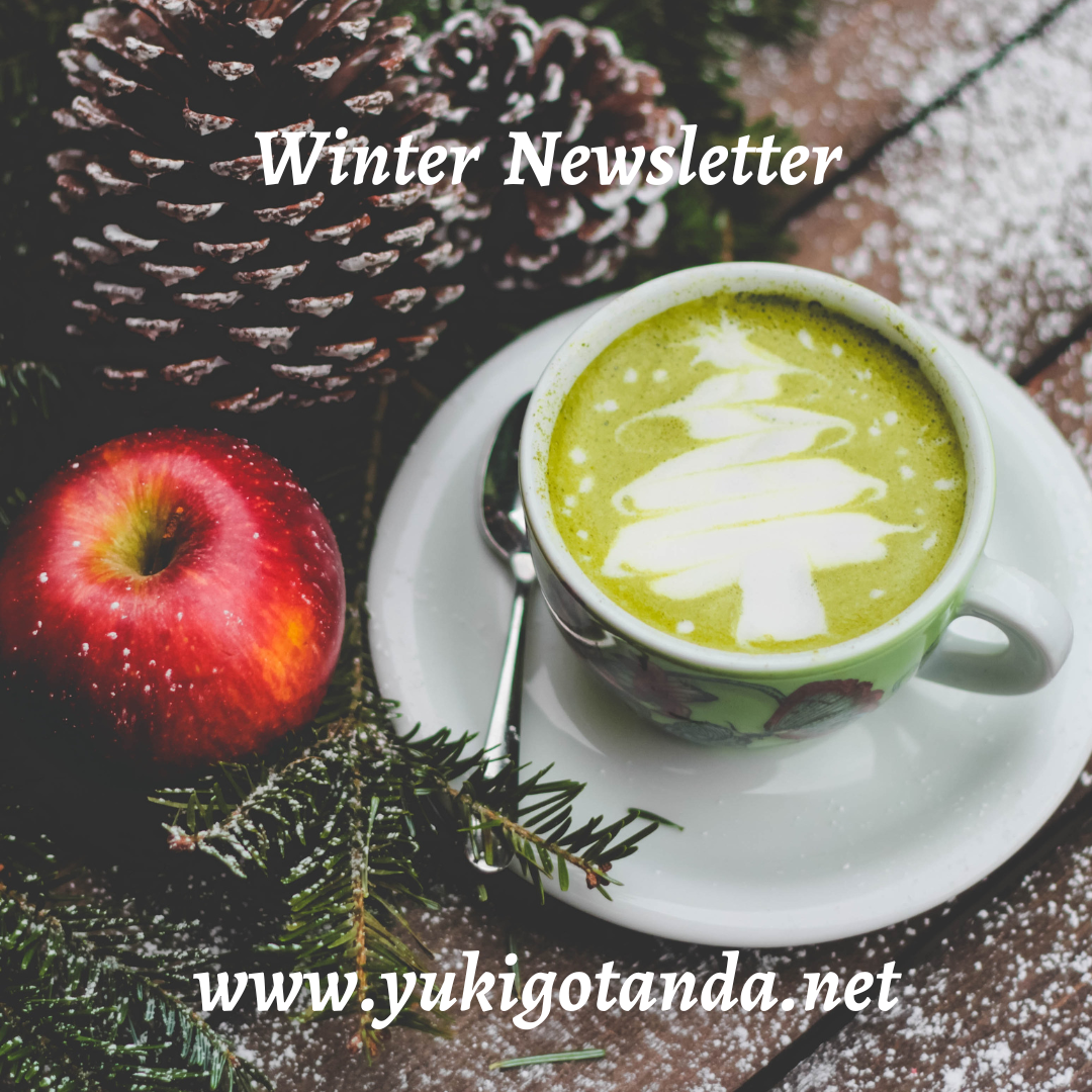 A Christmas-themed scene with a pinecone, a red apple, and a cup of green matcha latte with latte art shaped like a Christmas tree, on a snowy wooden surface.