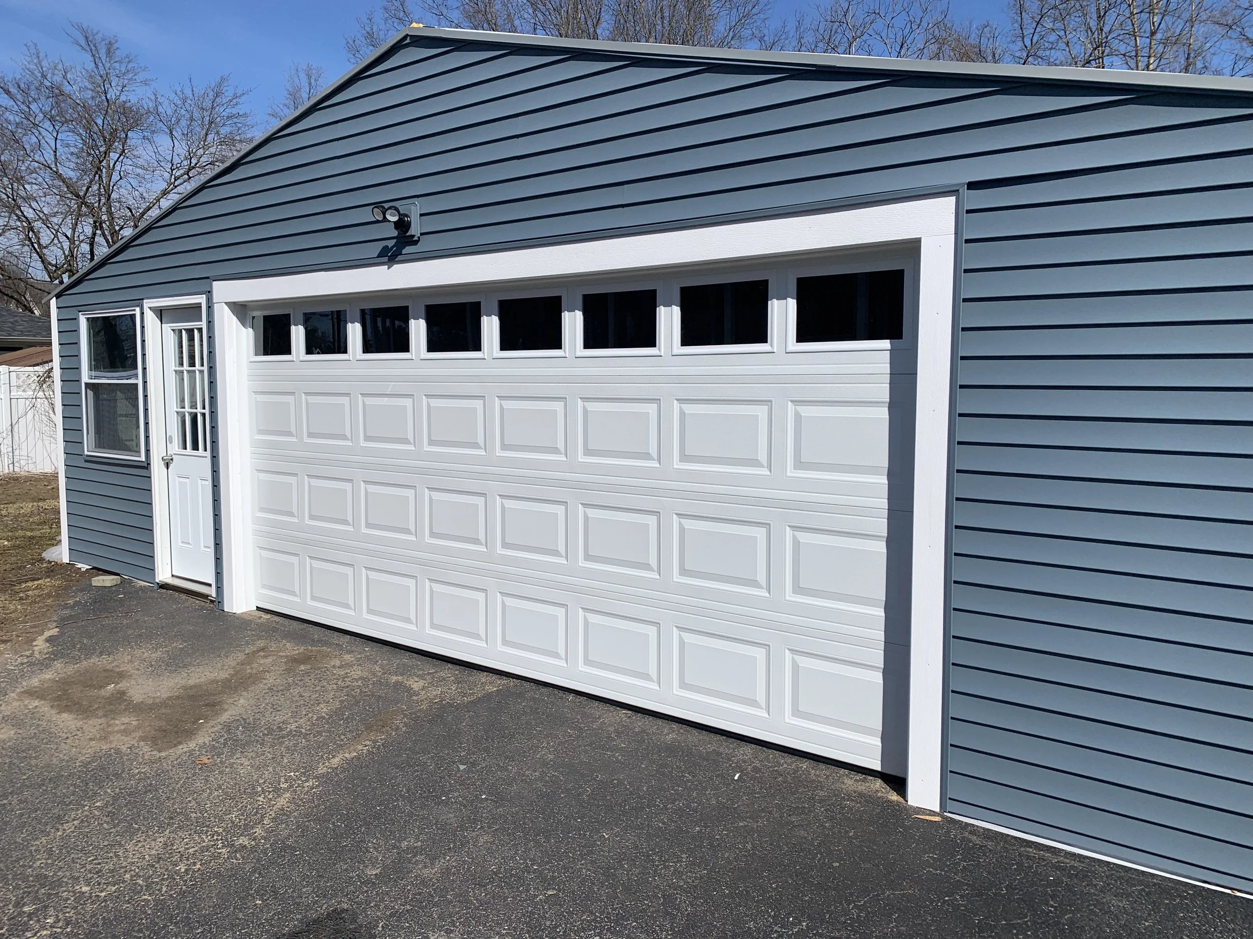 Raised panel garage door with windows installed in Saratoga Springs, NY