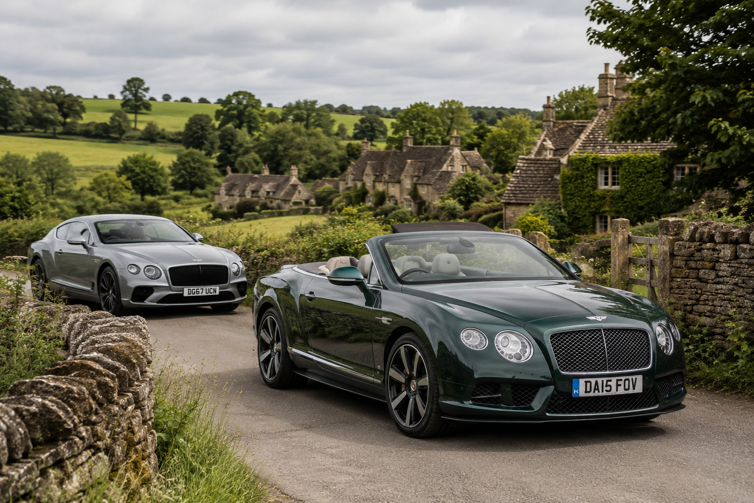A metallic silver luxury car parked behind a dark green convertible on a rural road, with stone cottages and lush green landscape in the background.