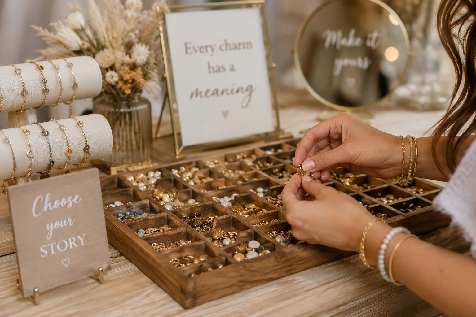 A guest selecting charms from the Charmed and Co. mobile charm display.