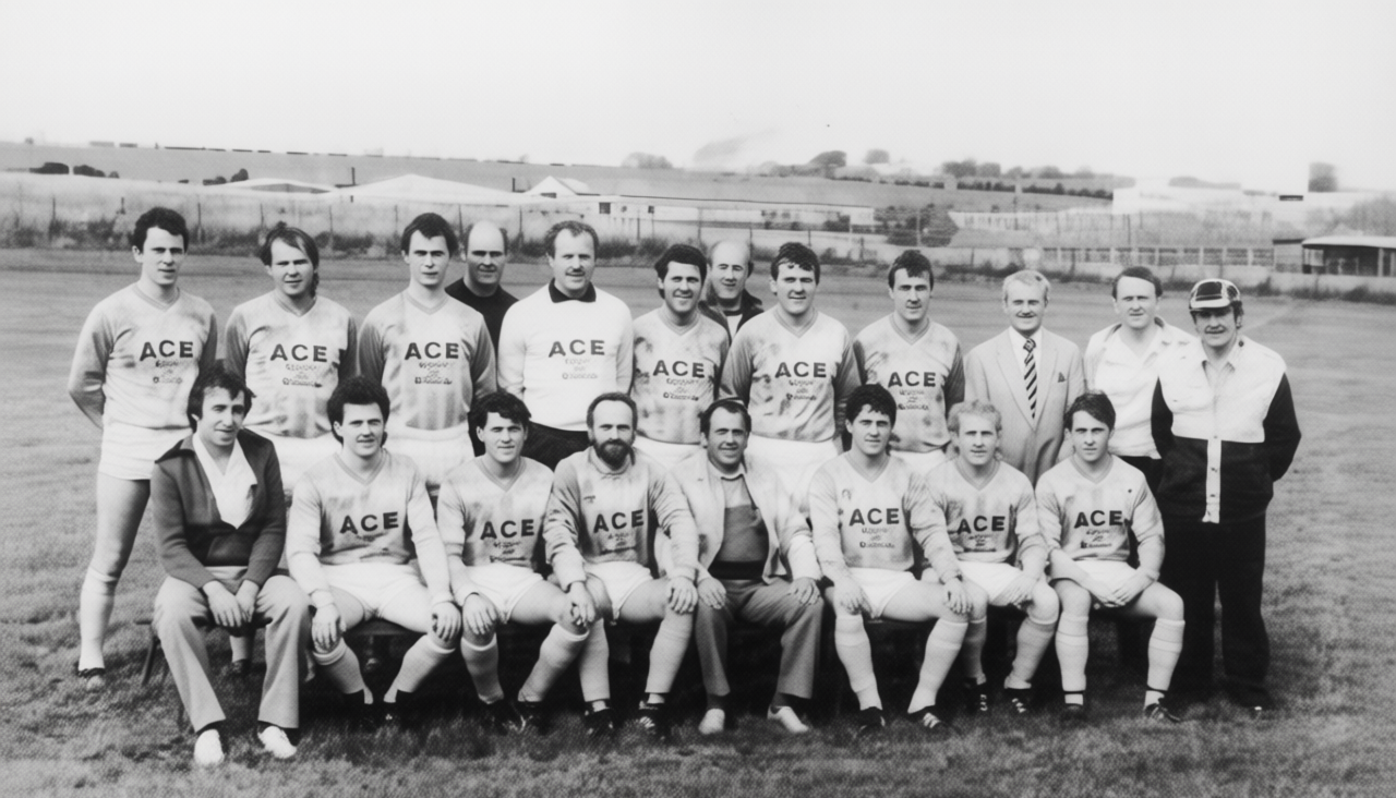 Black and white photograph of a vintage soccer team with players in uniform, coaches, and officials on a grassy field.