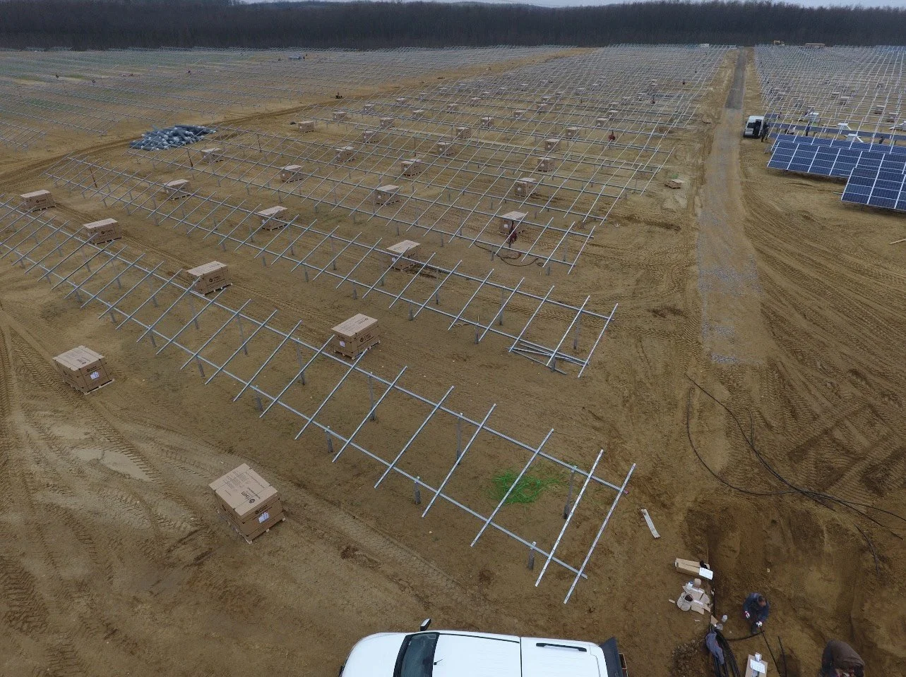 Mounting structures and photovoltaic modules progressing through coordinated installation phases.