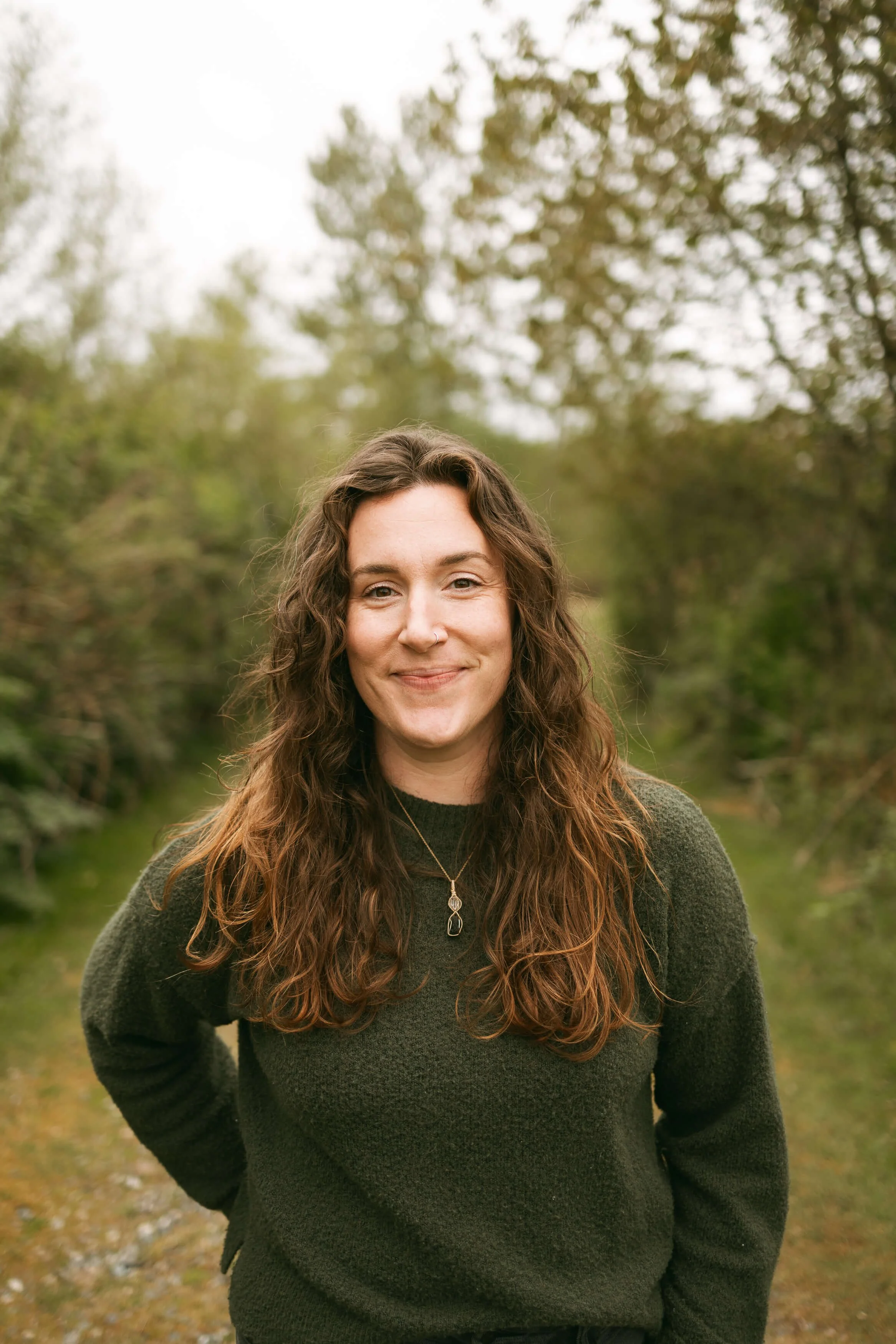 Therapist in Bellingham, WA smiling outside wearing a green sweater