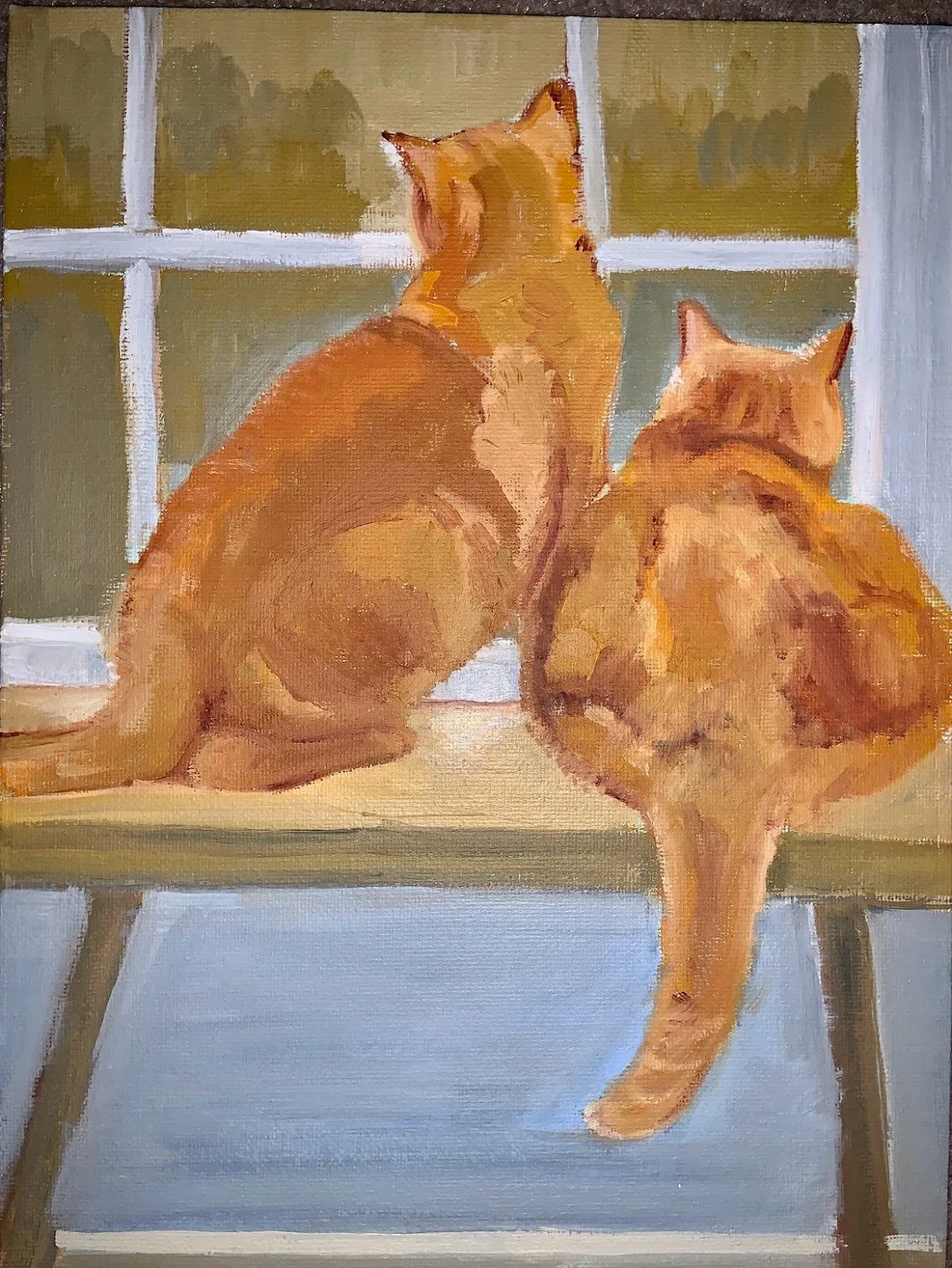Two orange tabby cats sitting on a green bench, looking out a window with divided panes.