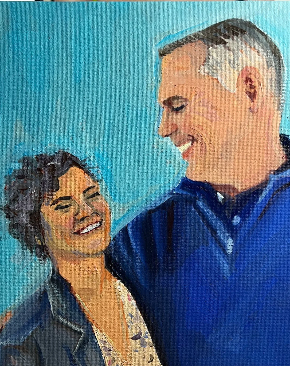 A painting of a smiling woman with short curly hair and a smiling man with gray hair and a navy blue shirt, sharing a joyful moment against a blue background.