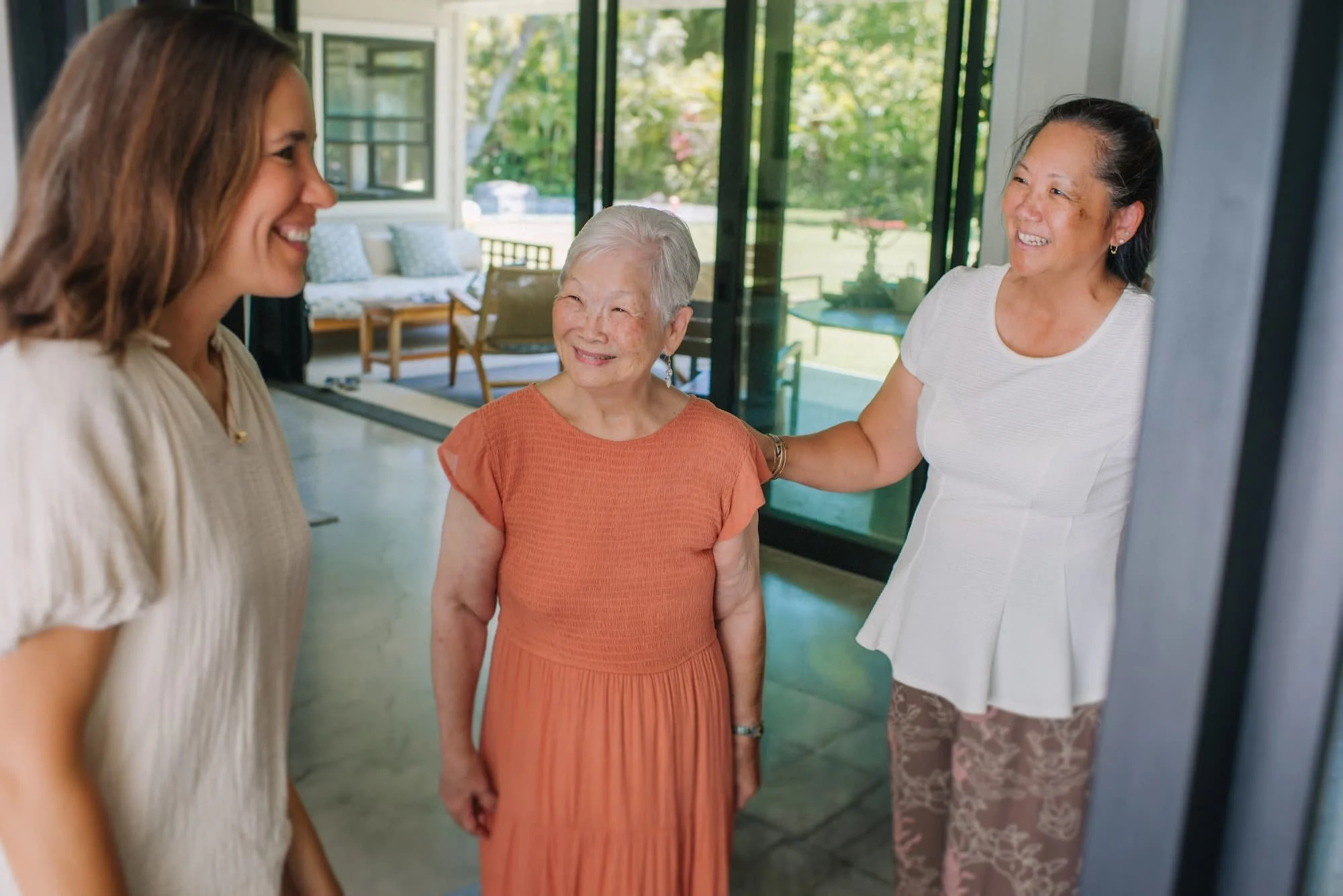 Nurse practitioner greeting a senior patient and her daughter at home