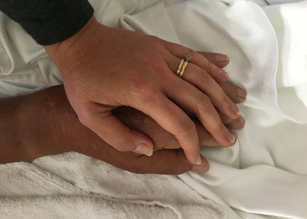 Lani Hubbard holding her father's hand