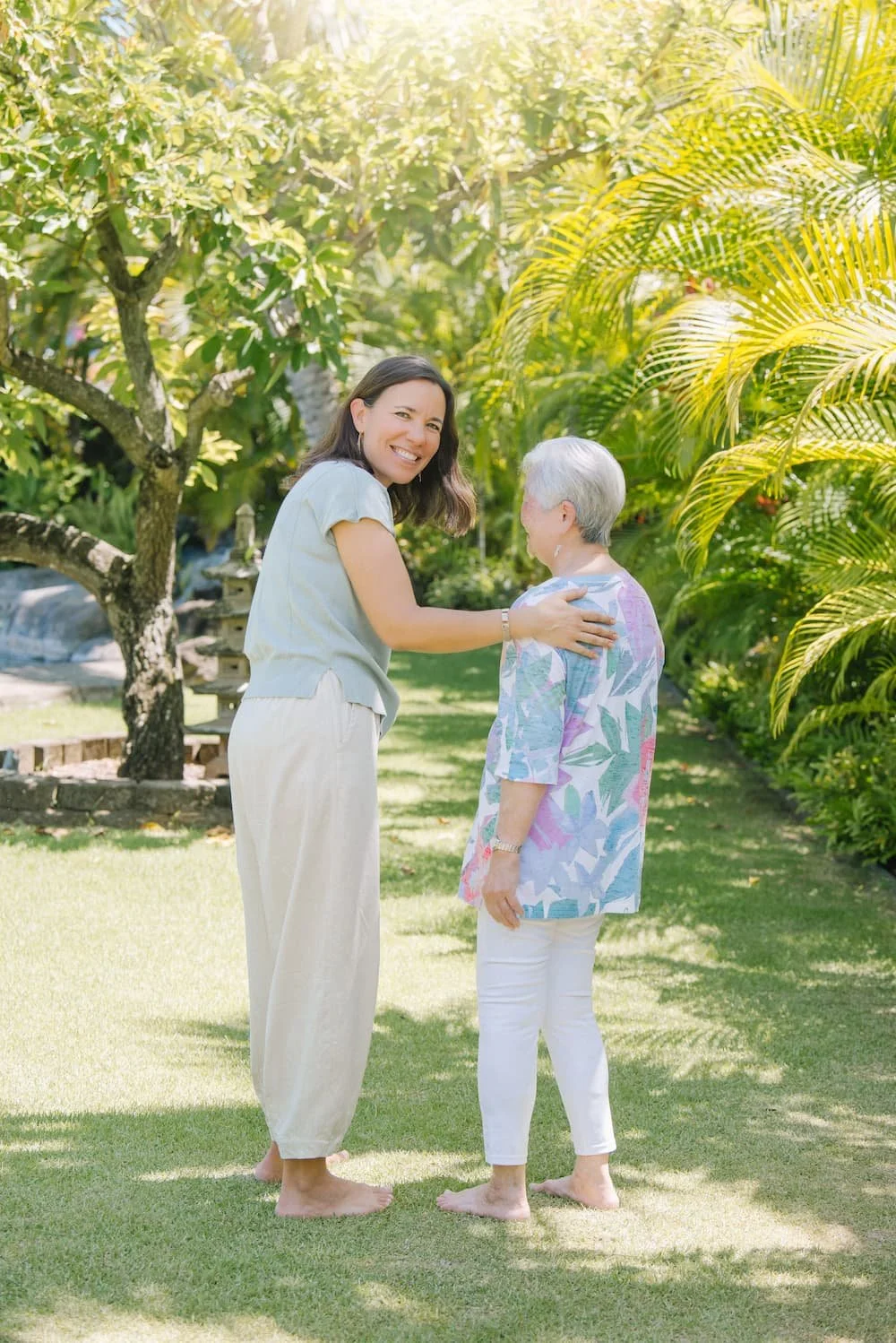 Lani Hubbard and a patient sharing a warm moment on a garden path