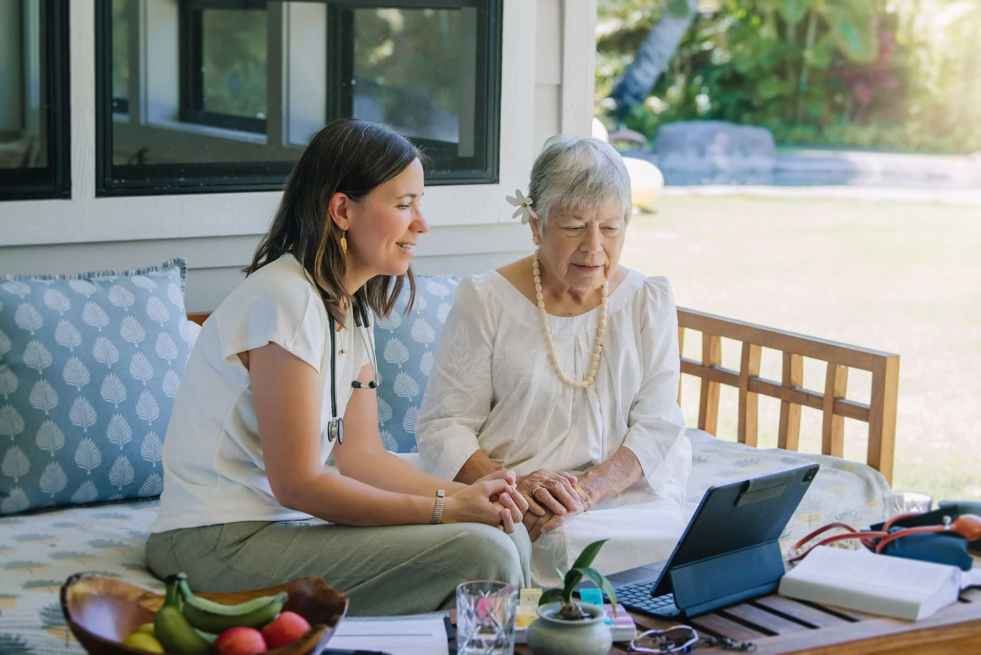 Nurse practitioner and senior patient reviewing information together on a tablet during an unhurried in-home visit