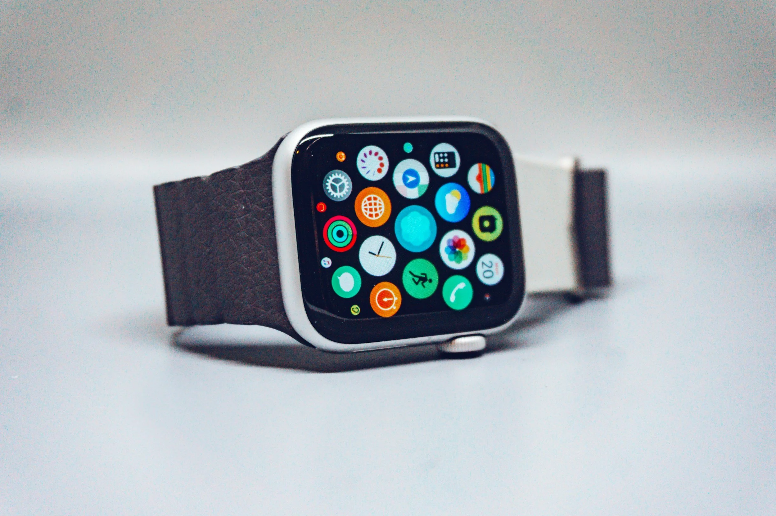 A close-up of a modern smartwatch on a wrist displaying a grid of tracking apps, illustrating sleep quality metrics and digital biometrics.