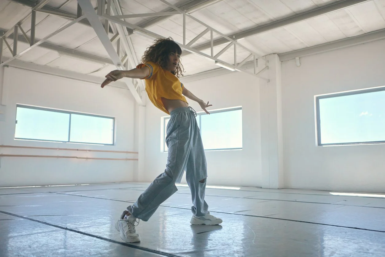 A stylish young K-pop dancer posing dynamically in streetwear, representing vibrant youth culture, modern movement, and everyday health curiosity.