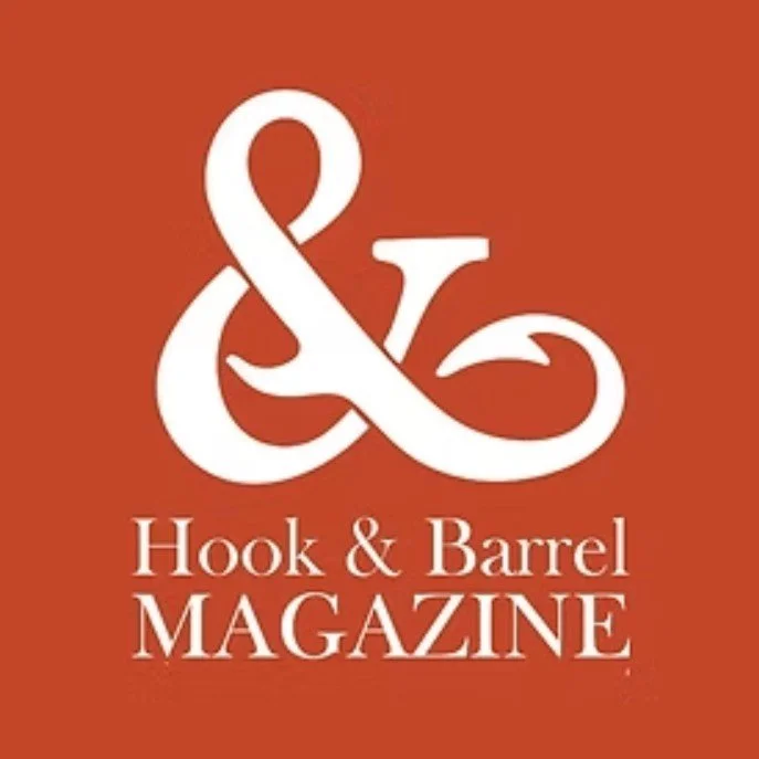 Logo for Hook & Barrel Magazine with a white ampersand symbol and the text 'Hook & Barrel MAGAZINE' on a rust-colored background.