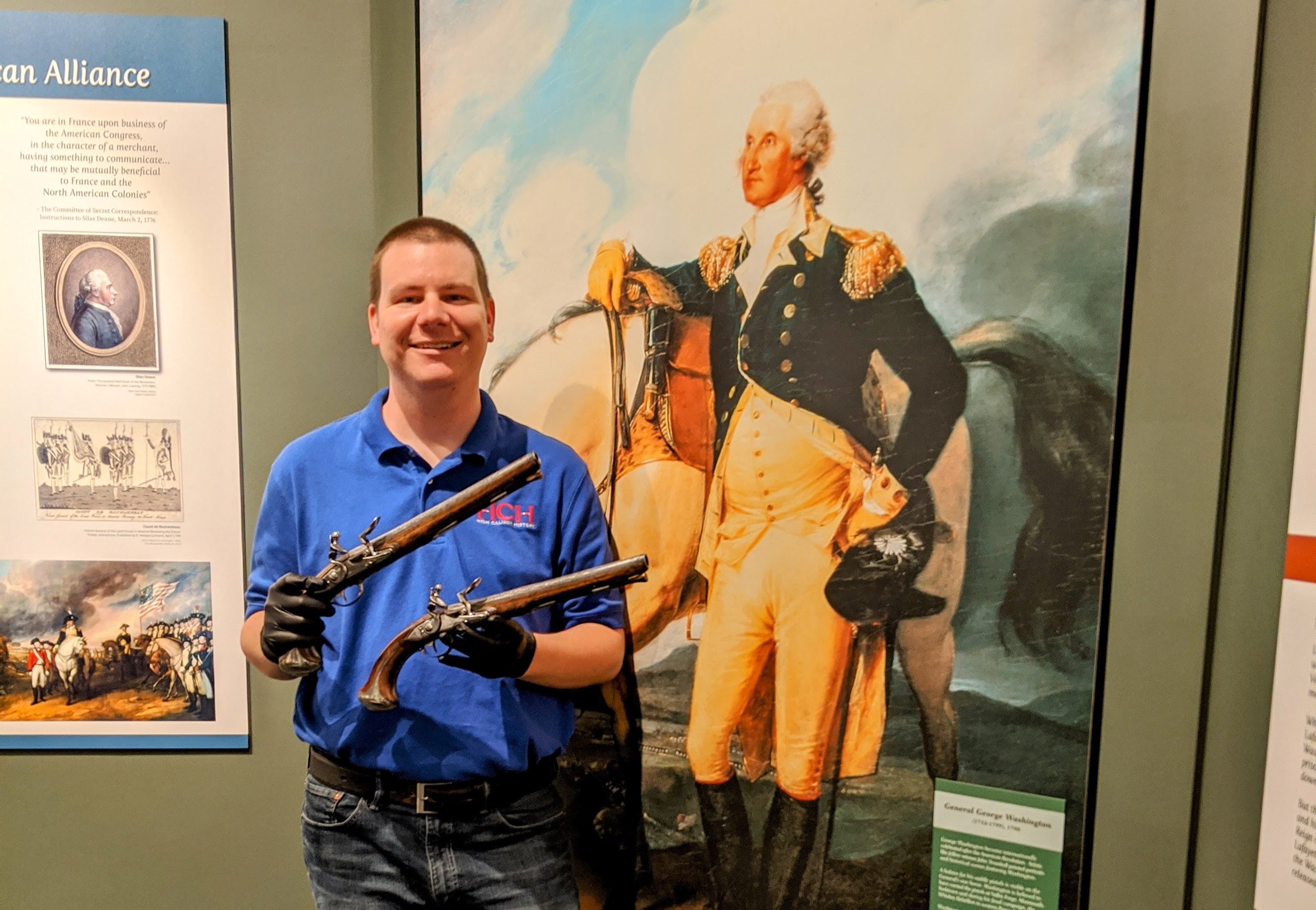 Logan Metesh holding George Washington's pistols.