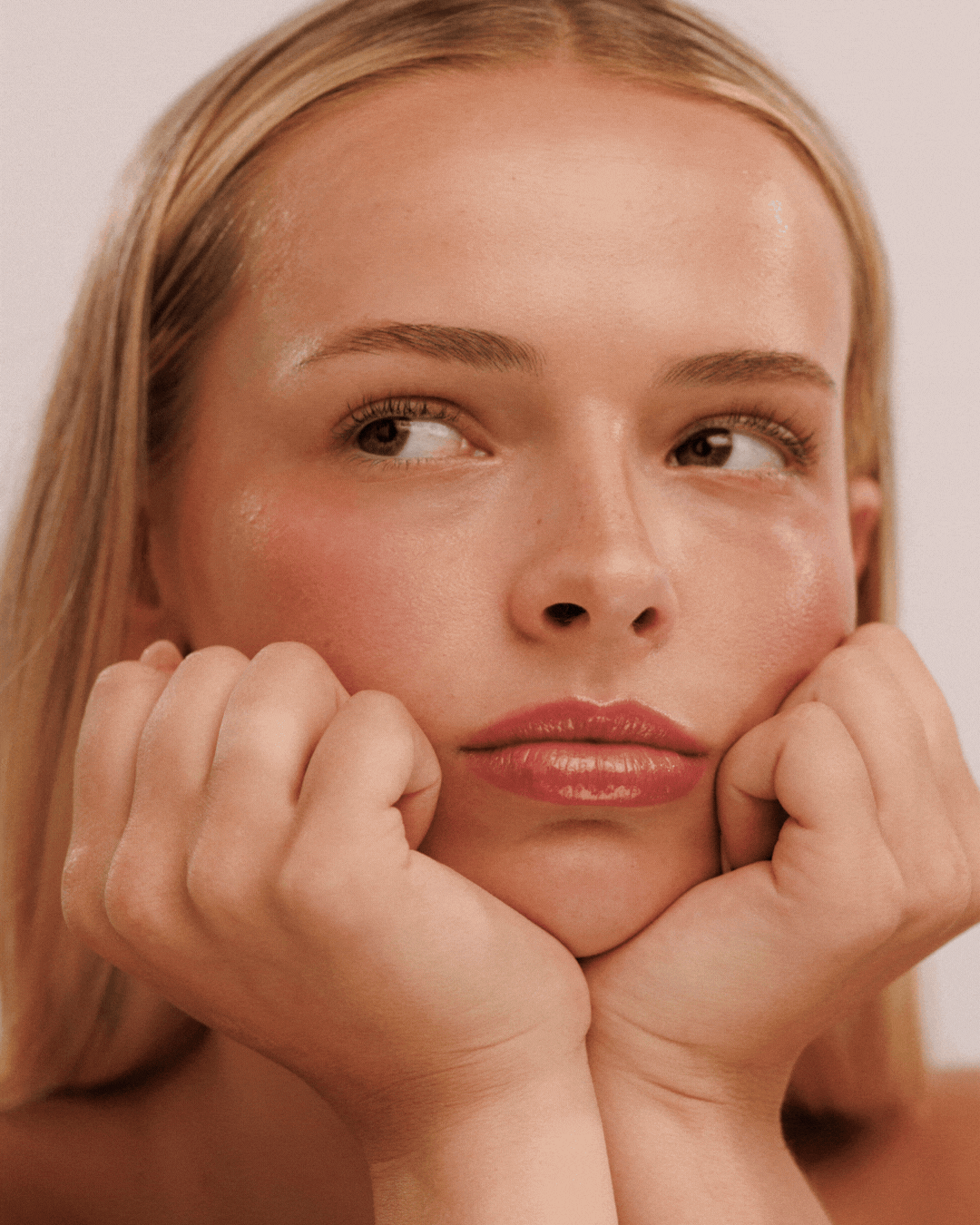 Close-up portrait of a fashion model resting her face on her hands with different expressions.