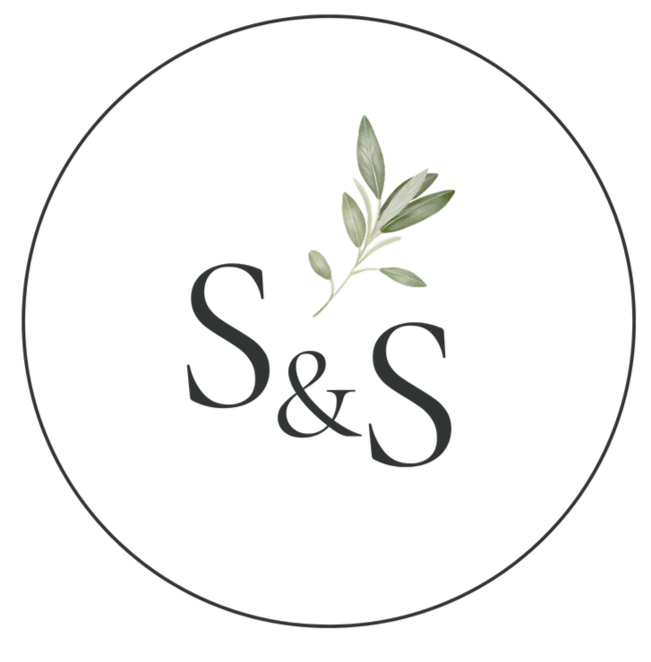 A circular logo with a black background, featuring a green leafy branch above the text 'S&S' in gray font.