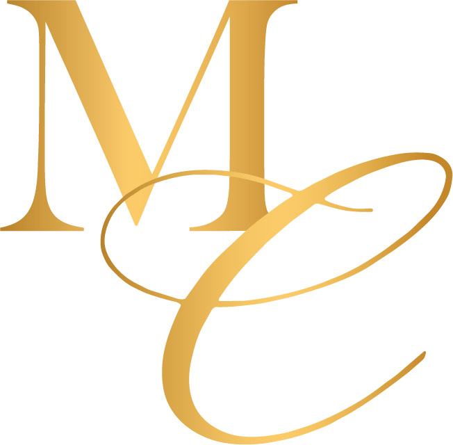 A golden MC monogram with a curved design.