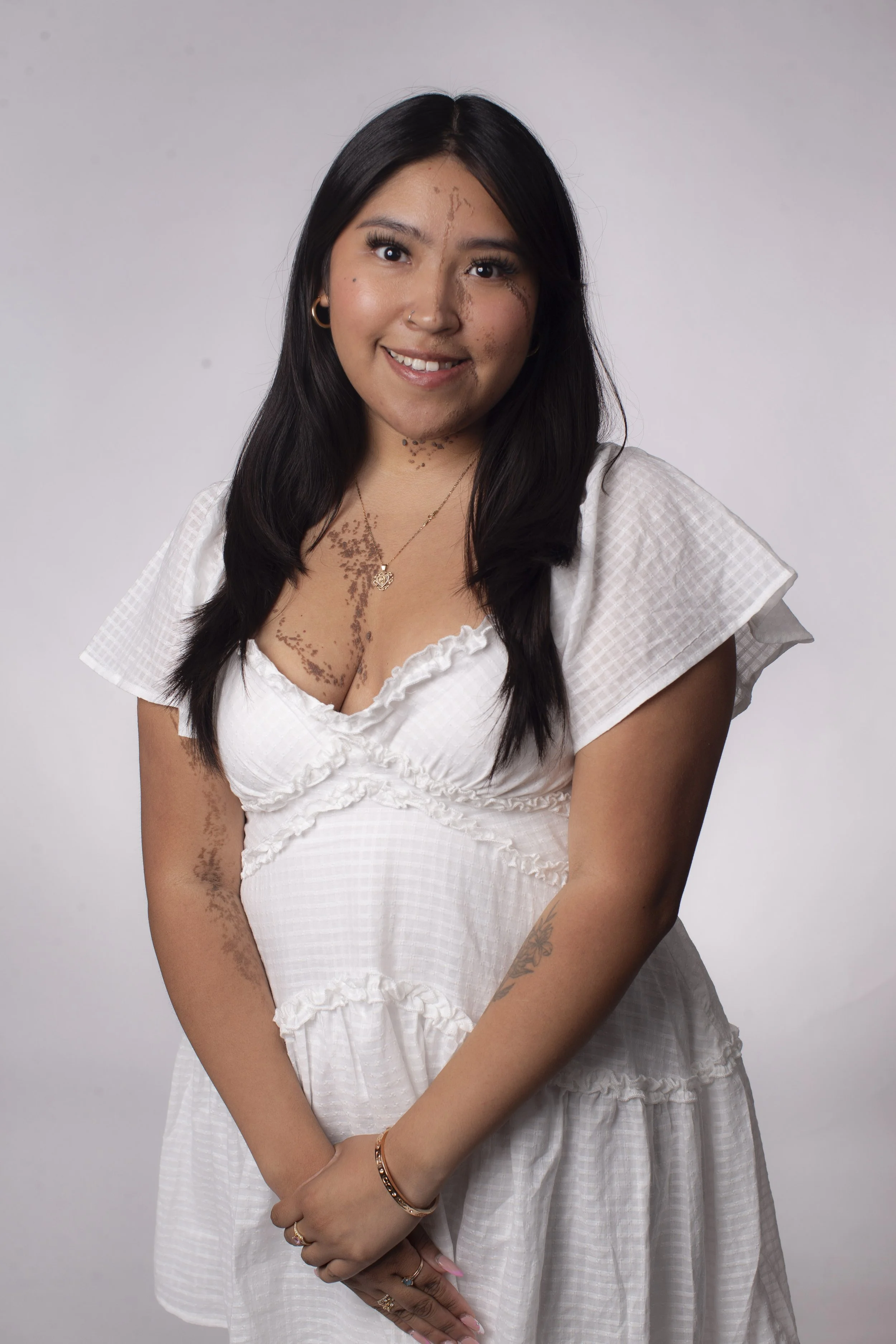 Sara Dominguez standing in front of a white screen