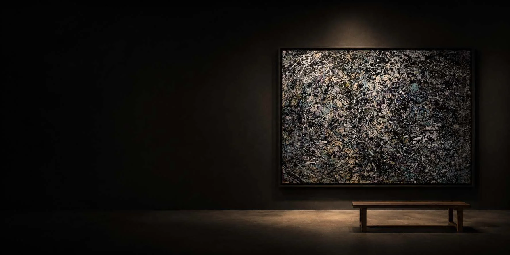 An abstract painting with intricate patterns of small leaves and branches, displayed on a dark wall with a bench in front.