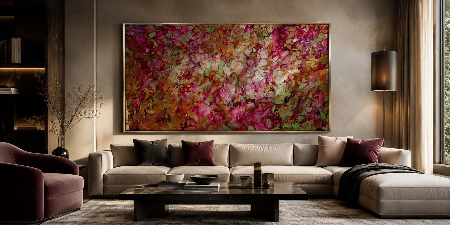 Living room with a large beige sectional sofa, purple and black pillows, a dark wood coffee table with decorative objects, a pink armchair, a tall black floor lamp, a colorful abstract floral painting on the wall, a window with beige curtains, and a dark bookshelf on the left.