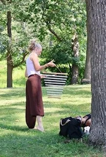 Tanya Johnson, founder of Rooted Yogi.ca guiding a Qigong practice in the park with sound facilitation, breathwork and gentle movement