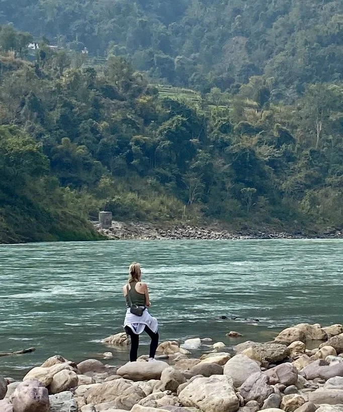 Meditating beside the sacred Ganges river in india, embracing stillness, mindful breathwork and a deep connection to nature