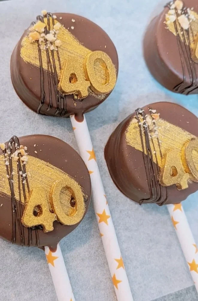 Peanut Butter cake pops with edible gold glitter paint and custom chocolate numbers