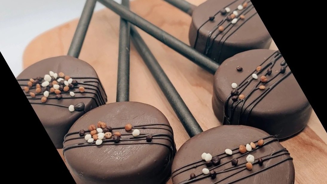 Chocolate cake pops with chocolate drizzle and crispy pearls