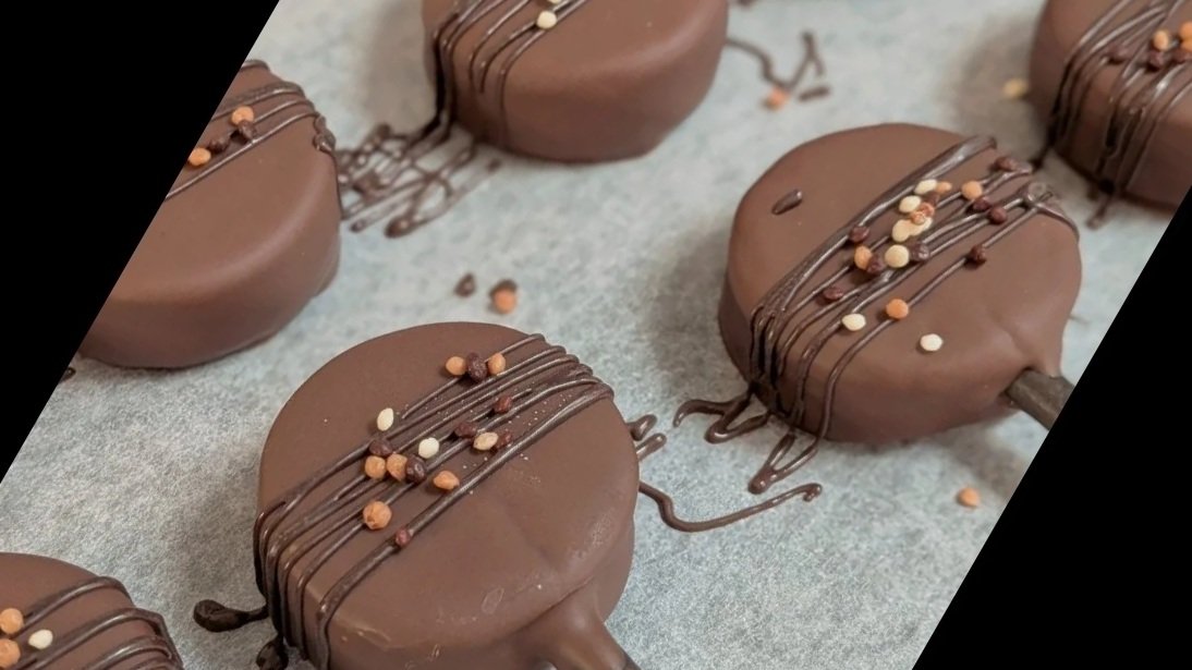 Chocolate cake pops with chocolate drizzle and crispy pearls