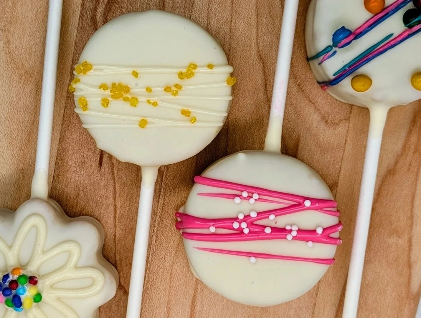 Funfetti Daisy, Lemon, Strawberry Vanilla and Funfetti disc cake pops with drizzle and sprinkles