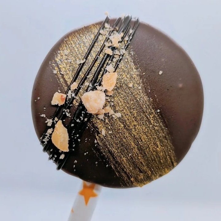 Peanut Butter cake pops with edible gold glitter paint and chocolate drizzle with chopped peanuts
