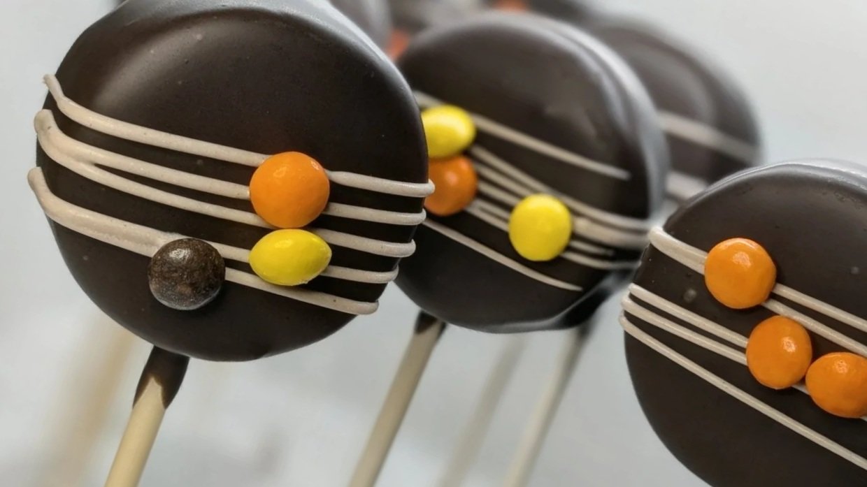 Peanut Butter cake pops with chocolate drizzle and Reese's Pieces