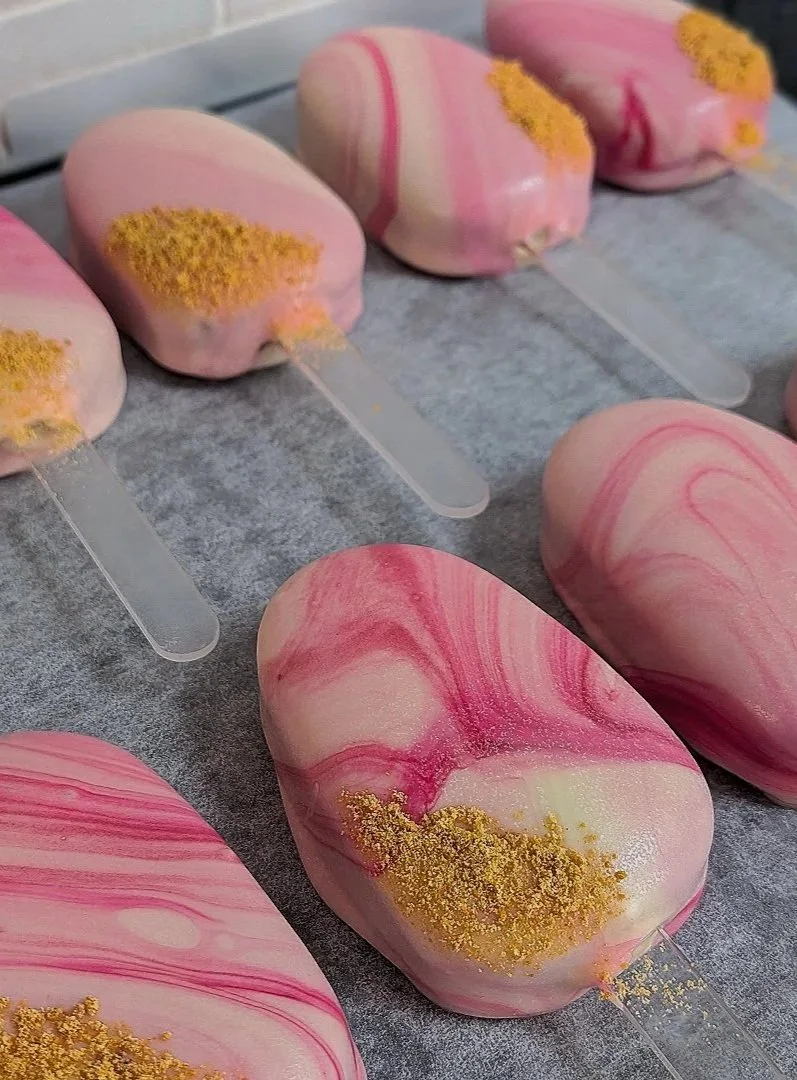 Strawberry Cheesecake cakesicles with clear acrylic sticks