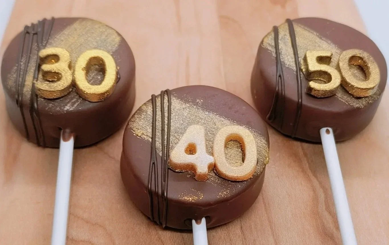 Peanut Butter cake pops with edible gold glitter paint and custom chocolate numbers