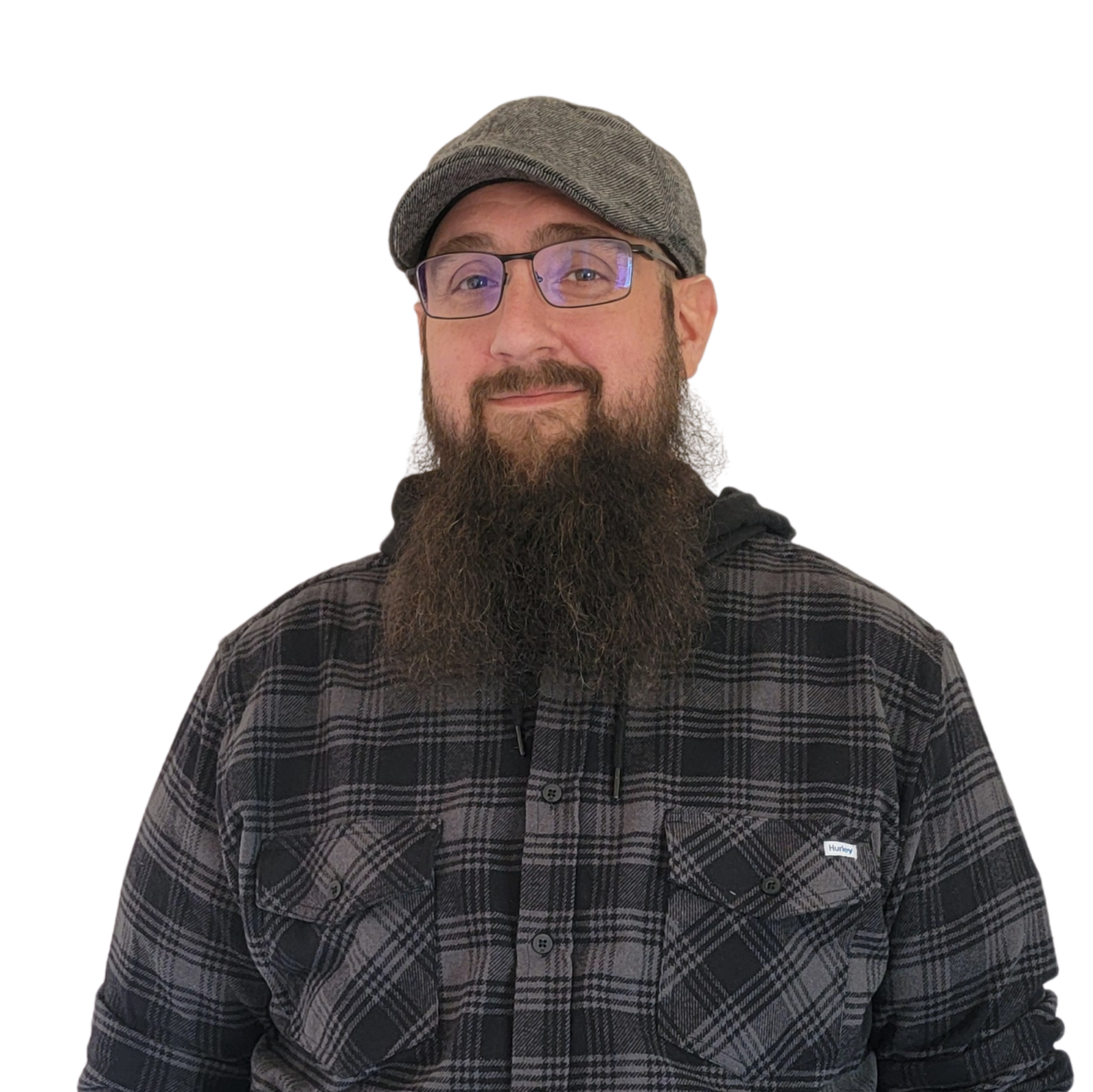 A man with glasses and a beard wearing a gray cap and a black-and-gray plaid jacket, smiling at the camera.