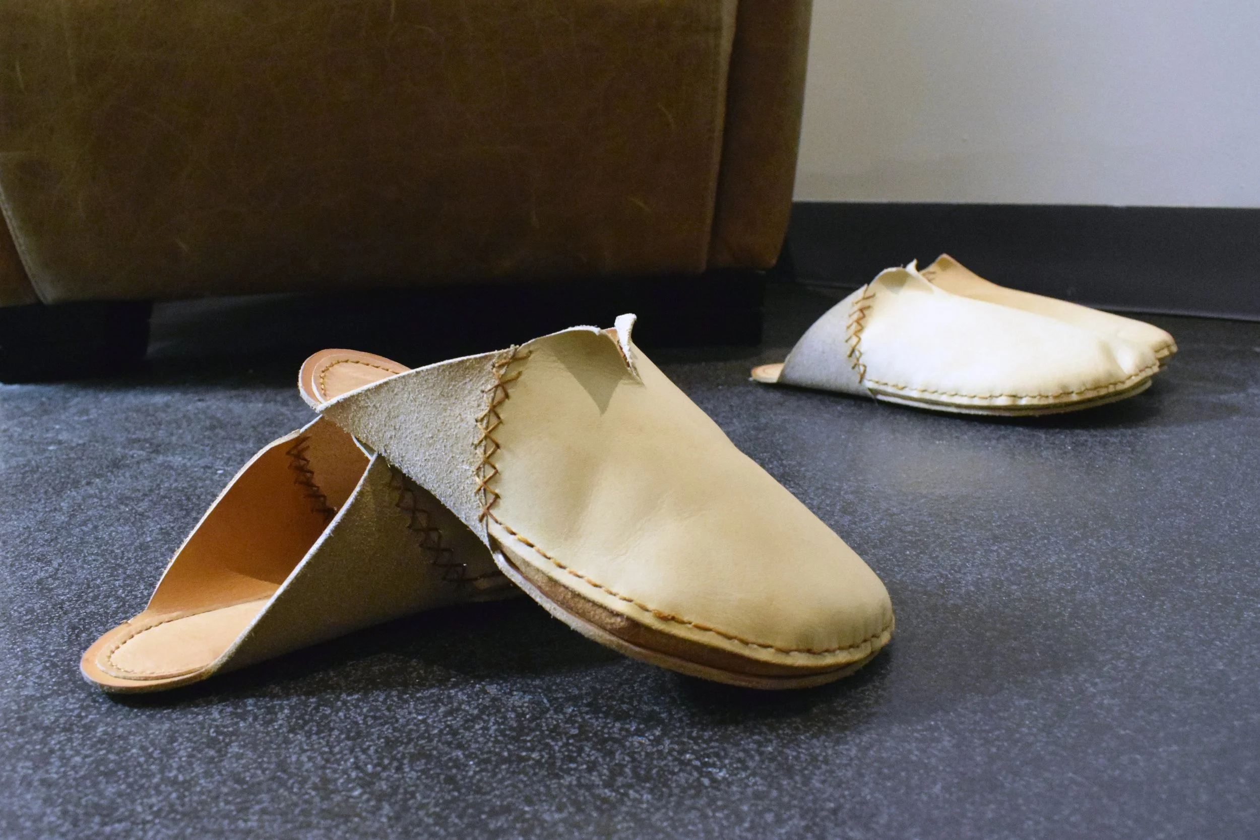 Handmade leather slippers forming part of the immersive installation.