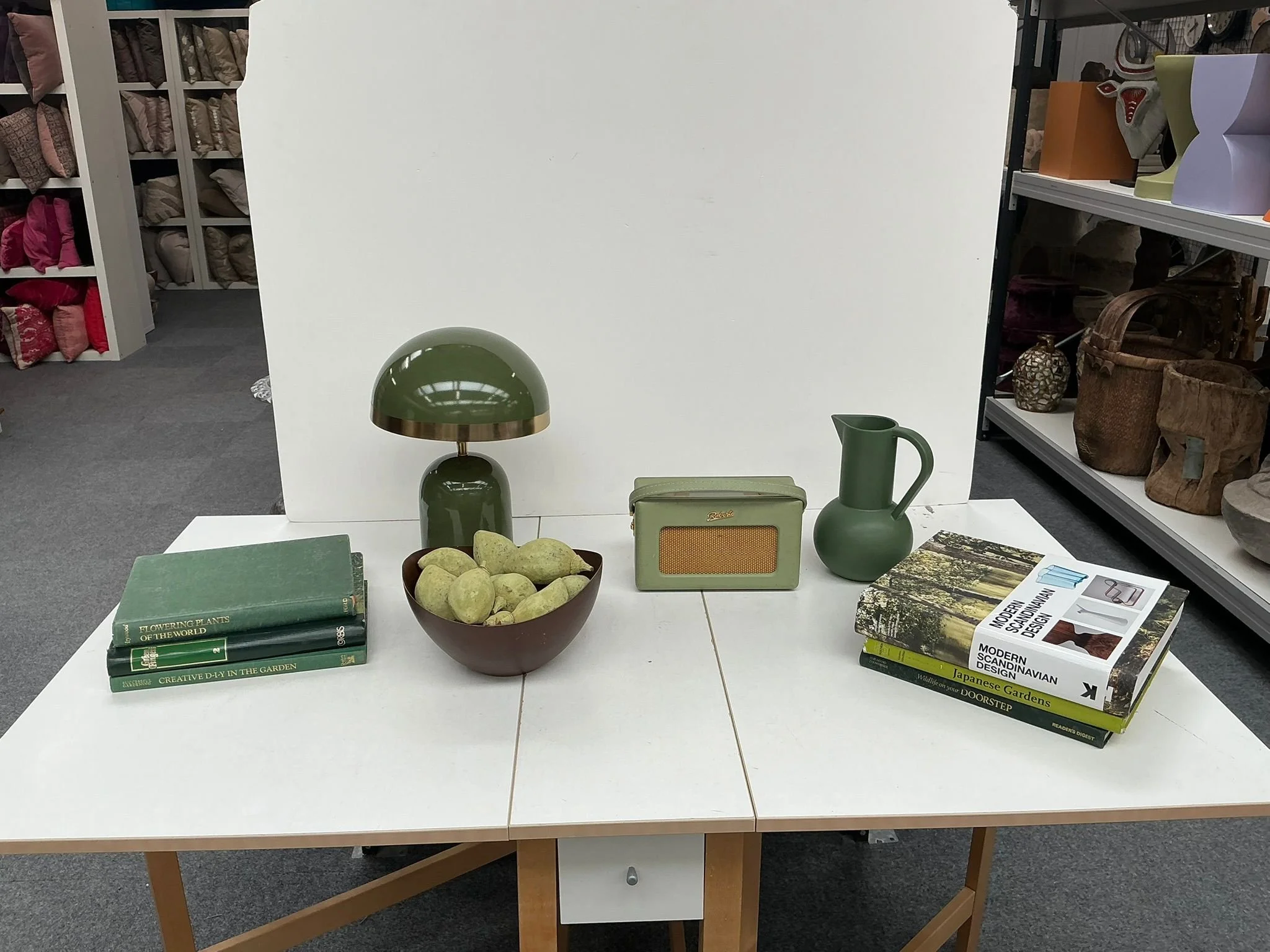 A display table in a prop store showing items selected to create a showcase living room feel.
