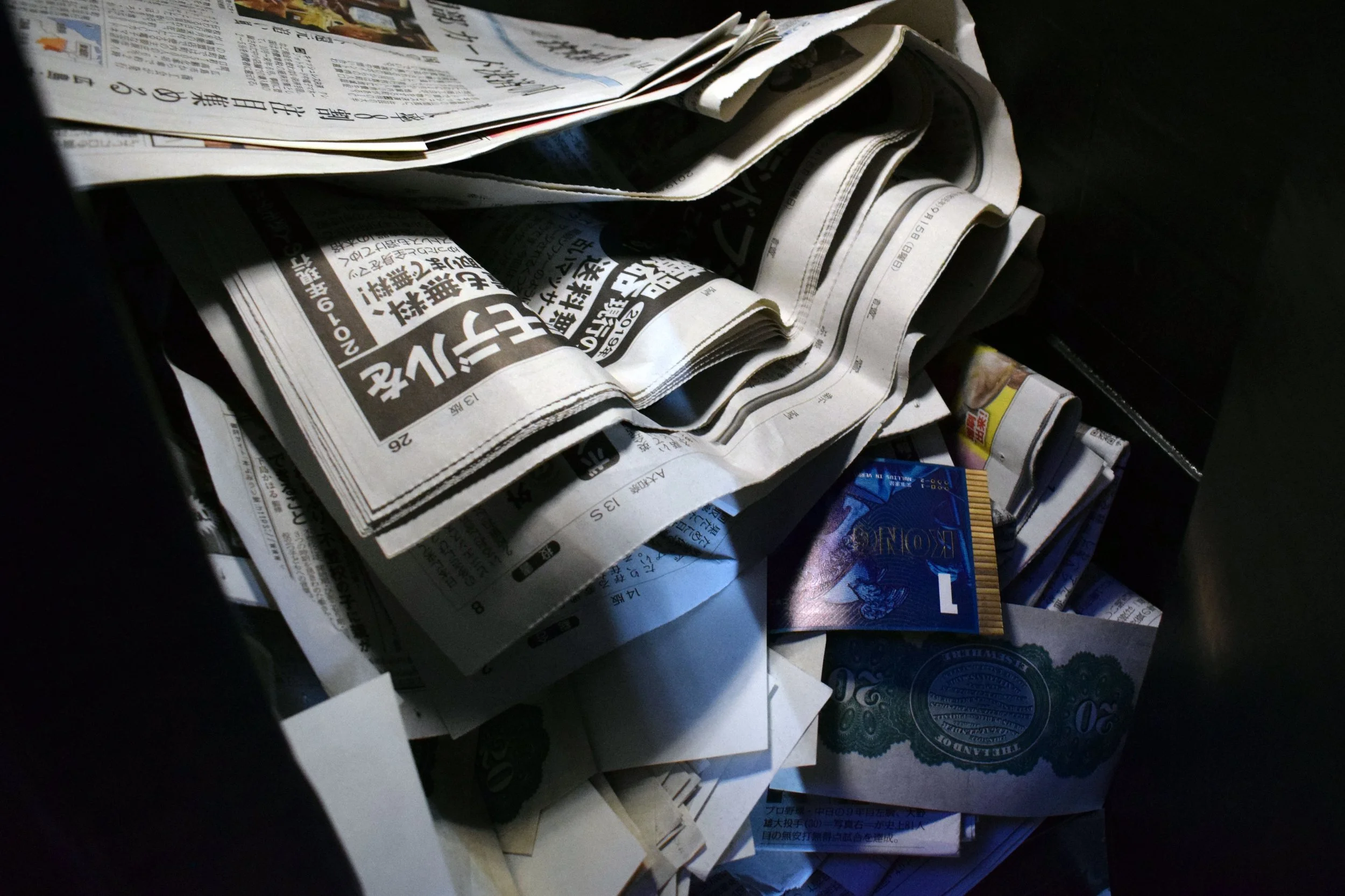 Newspapers, printed material and objects used to create the immersive ‘Present’ environment exploring contemporary money.