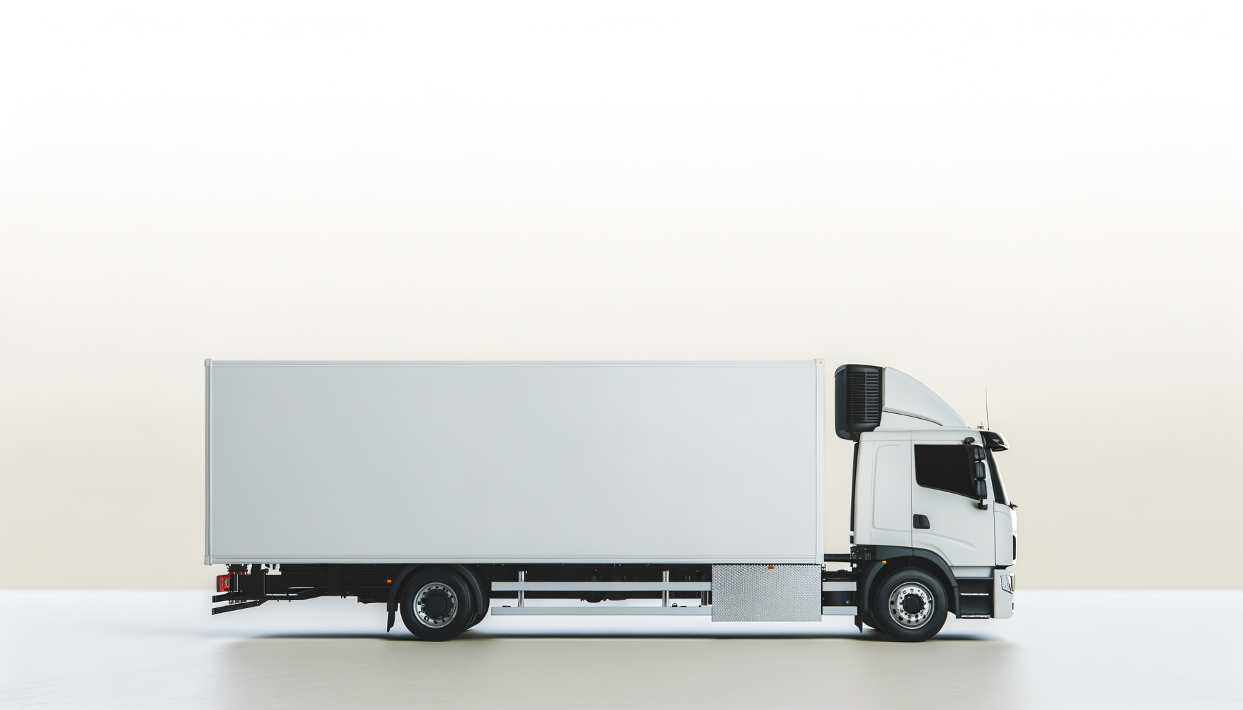 Side view of a large white delivery truck with a box cargo area against a plain light background.