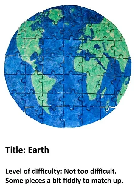 A puzzle piece map of Earth showing continents in green and oceans in blue, assembled in a circular shape.